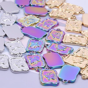 Colorful butterfly pendant necklace set in gold, silver, and iridescent stainless steel