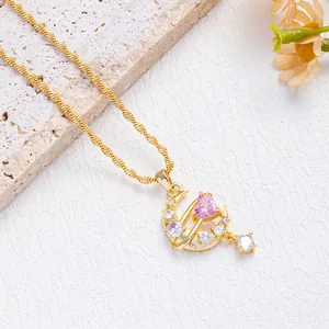 Pink heart moon necklace with gold twisted chain and sparkling diamonds on a stone base