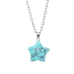 Close-up of star-shaped turquoise pendant necklace with a minimalist silver chain