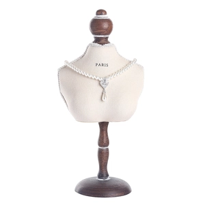 Classic white pearl necklace with teardrop pendant displayed on elegant bust stand