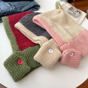Detailed knit texture of thick balaclava winter hoods in red, grey, and pink colors