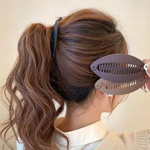 Detail showing the double-row interlocking teeth and matte finish of the banana hair clip
