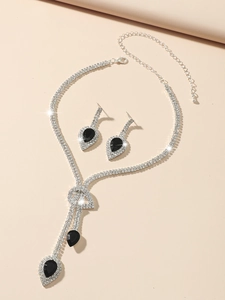 Close-up of bridal jewelry set with silver rhinestones and black pear-cut stones