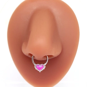Macro shot of a silver nose hoop with a pink heart-shaped opal stone on a nose model