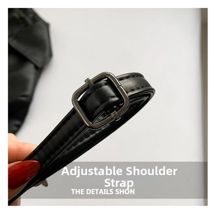 Detailed macro view of adjustable black PU leather shoulder strap with dark metal buckle
