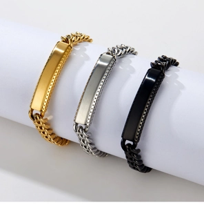 Detail of three curb link bracelets in gold, silver and black with brushed metal plate