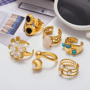 Detailed set of gold titanium rings with natural stone, pearls and turquoise accents