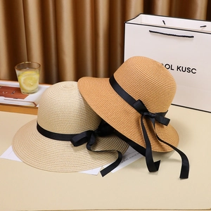 Elegant wide brim straw sun hats in beige and caramel with black ribbons for summer