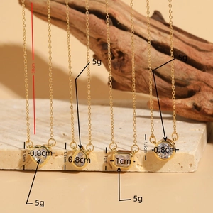 Elegant gold zircon necklace set with geometric pendants on natural wood and stone backdrop