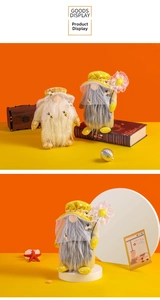Close-up of adorable bee-themed gnome plush dolls with yellow hats and soft faux fur beards