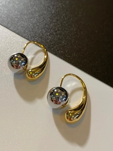 Detailed view of French vintage water drop earrings with metallic gold and silver balls