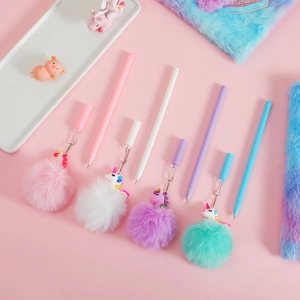Close-up of four colorful unicorn pens with matching fluffy pompom pendants and charms