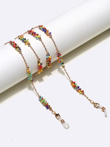 Detail view of colorful beaded eyewear chain with gold links and silicone loops