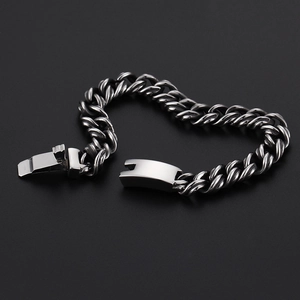 Detail of silver steel Cuban link chain bracelet with vintage finish on black background