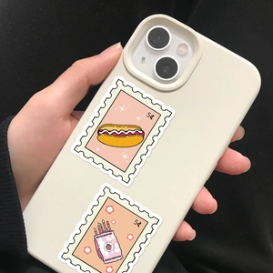 Close-up of stamp-style food stickers with hot dog and cookie designs on a phone case