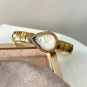 Luxury gold teardrop watch for women with a rhinestone bezel and metal link bracelet