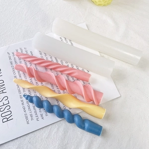 Spiral candle silicone molds displayed with colorful pink, yellow, and blue finished candles