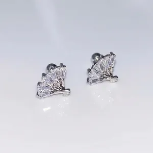 Macro detail of fan-shaped stud earrings with rectangular and round cubic zirconia stones