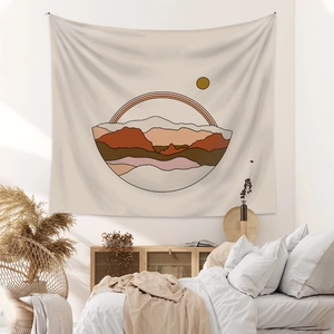 Bohemian tapestry featuring abstract mountains and sun decor in a modern cozy bedroom setting