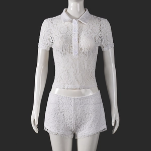 Detail of white lace two-piece set featuring a polo collar top and matching shorts on mannequin