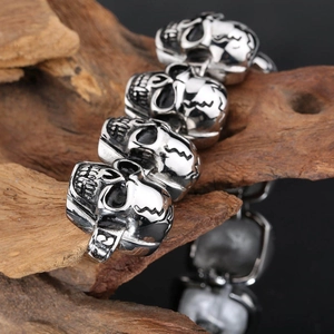 Macro shot of silver stainless steel skull bracelet with number 13 on dark wood