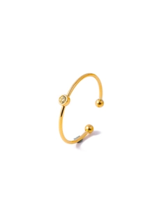 Macro detail of gold-plated minimalist open ring with round zircon and small ball accents