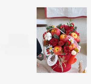 Detailed Christmas flower bucket with red roses, apple and golden 'MERRY' lettering