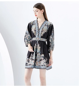 Detail of V-neckline and bohemian floral print on vintage black mini dress