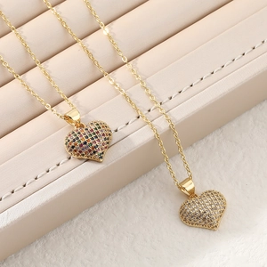 Luxury heart necklaces with multicolored and white zircons on gold chains in a box
