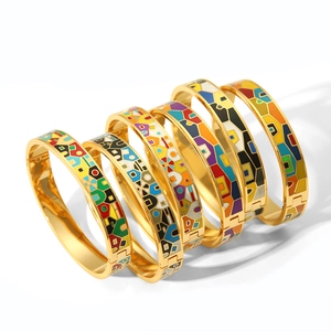 Set of six gold stainless steel enamel bangles with geometric abstract patterns