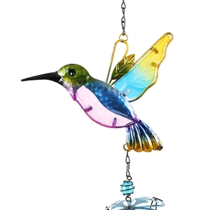Close-up of a colorful metal and glass hummingbird chime with vibrant painted details