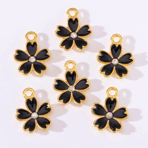 Detail of six black enamel cherry blossom pendants with gold edges and center rhinestones