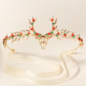 Golden Christmas reindeer antler hairpiece with festive red and green beads and silk ribbons