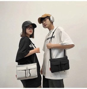 Front view of black and beige nylon messenger bags with double drawstring pockets