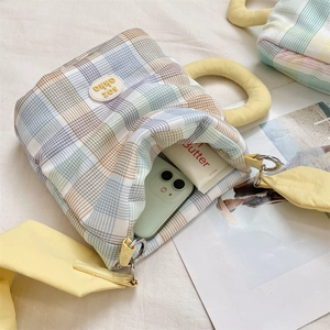Detail showing internal space of cute plaid water bottle bag with phone and cosmetics