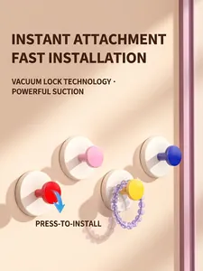 Close-up of suction cup hooks showing vacuum lock technology on a smooth wall surface