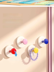 Close-up of suction cup hooks showing vacuum lock technology on a smooth wall surface