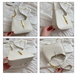 Detailed views of creamy hobo bag with gold piston clasp and chain strap detail