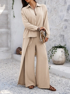Detail view of beige cotton-linen long shirt with side slits and matching wide-leg trousers