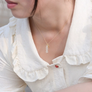 Close-up of golden S925 silver MAMA letter pendant necklace with sparkling pavé crystals