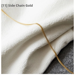 Detail of a golden curb chain necklace showcasing polished metal rings and fine texture