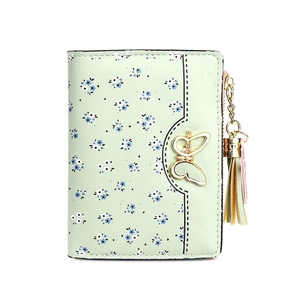 Short bi-fold light green wallet with blue floral patterns and golden butterfly buckle