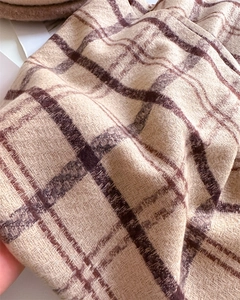 Macro detail of beige and brown checkered cashmere-feel fabric with soft texture