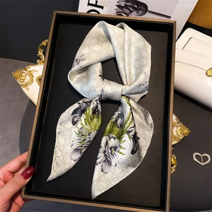 Elegant floral silk scarf in a luxury black gift box with a cream base and black flower print