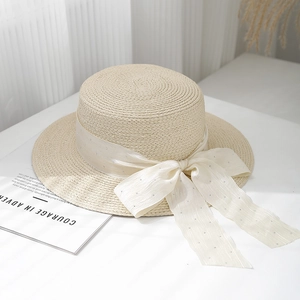 Chic beige straw boater hat with shimmering rhinestone ribbon bow for sun protection