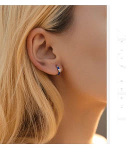 Detailed view of S925 silver heart hoop earring with blue enamel and zircon on model