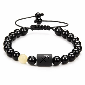 Detail of braided black obsidian bead bracelet featuring a Sagittarius zodiac sign bead