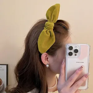 Elegant mustard green velvet oversized bow headband for women featuring a high-crown design