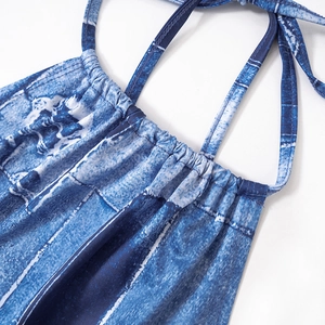 Close-up of blue denim print halter dress featuring slim ties and gathered chest detail