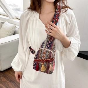 Ethnic style woven crossbody chest bag with colorful tassels and patterned shoulder strap